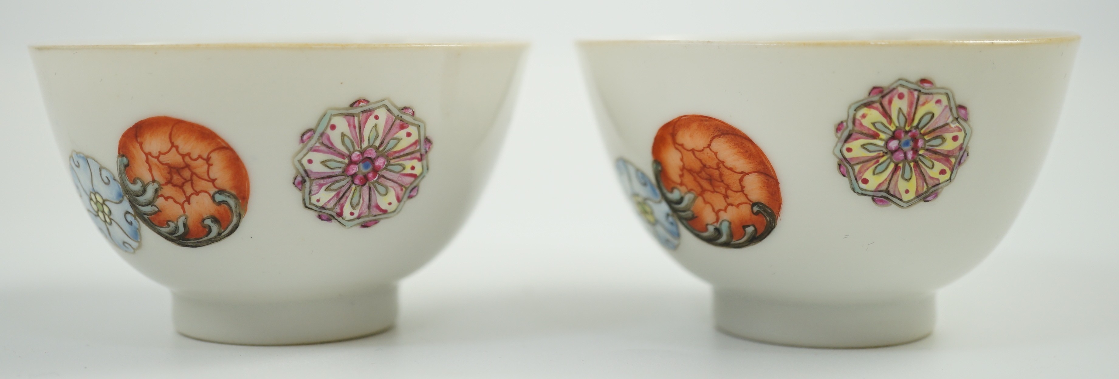 A pair of Chinese enamelled porcelain tea bowls, Qianlong seal marks, 7cms diameter